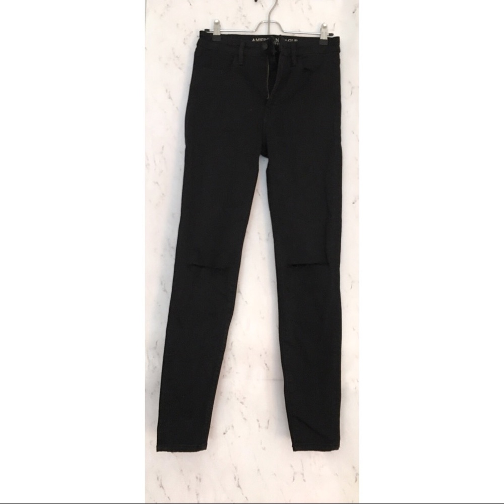 High waisted, distressed black jeans